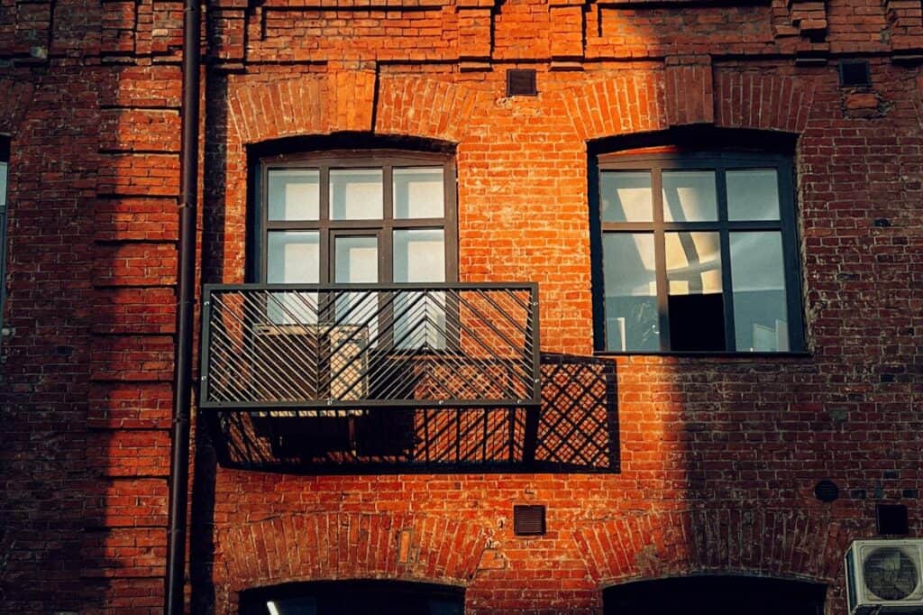 A brick apartment with glass windows
