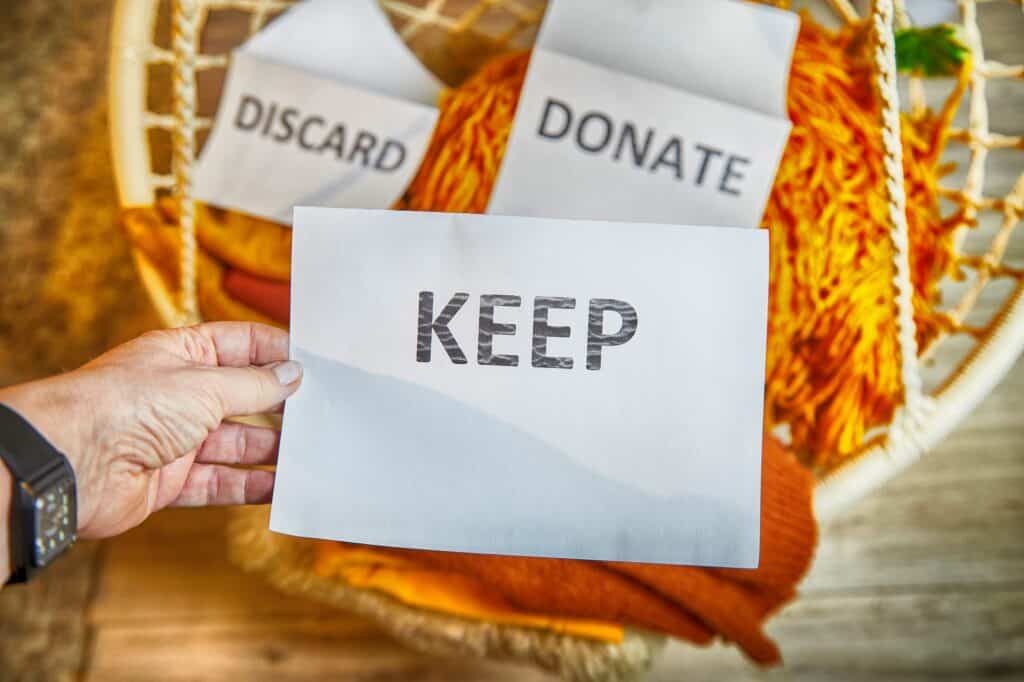 Signs with the words: Discard, Donate, and Keep in the concept of decluttering