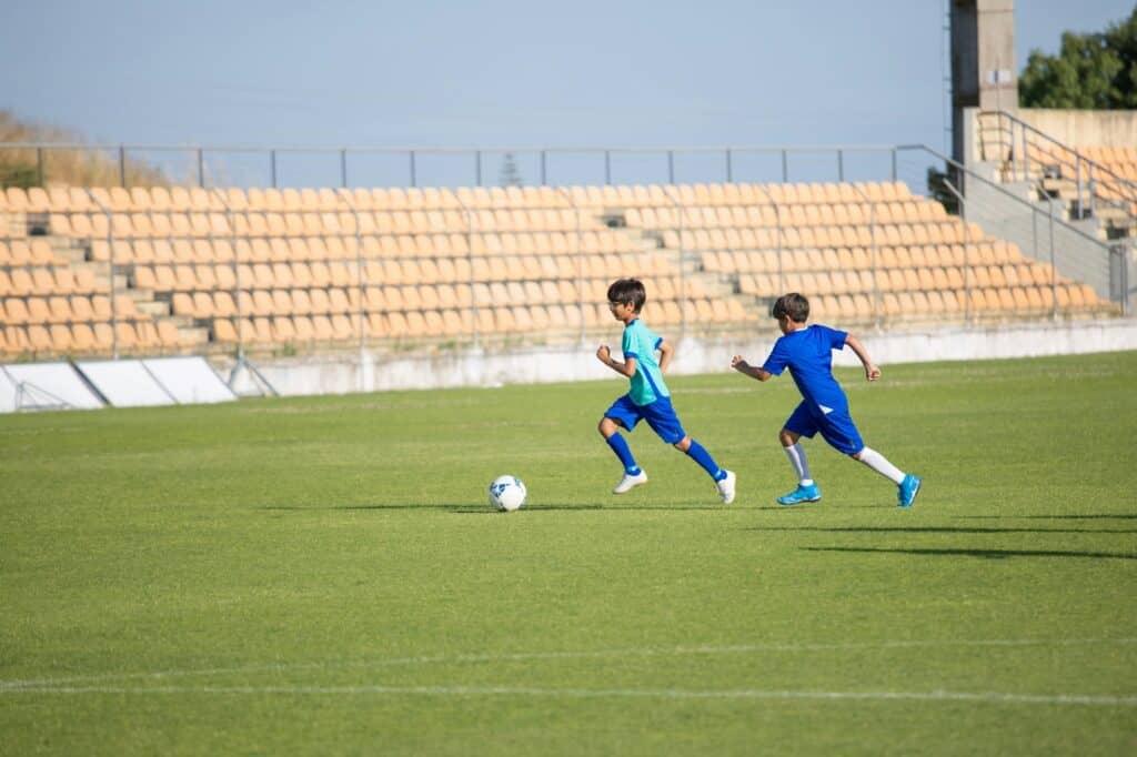 Students practising football on their school's football field