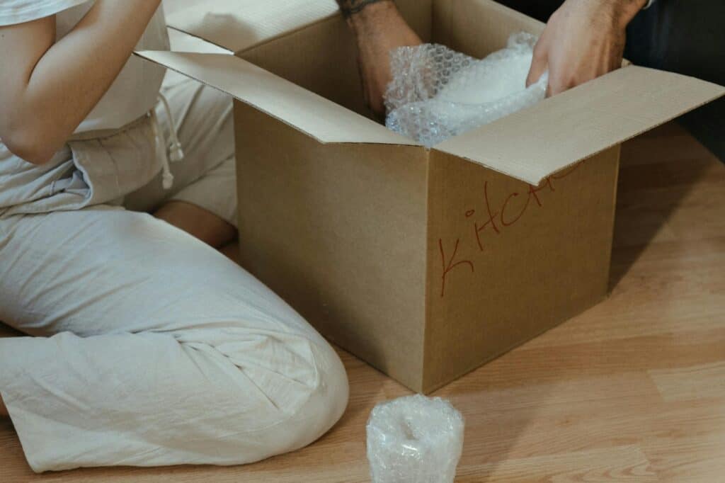 A couple is DIY packing kitchen items