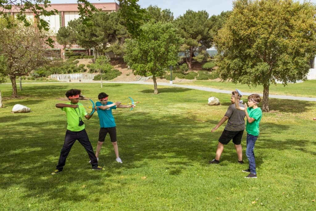 Young boys playing in a green space in the concept of parks and green spaces in Barnet.
