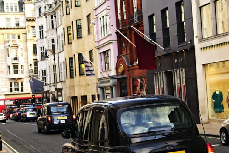 Black cabs on a shopping street in London in the concept of 'how to use Barnet's public transport'.