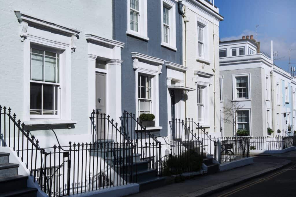 Row of townhouses in neutral colours with steps and railings