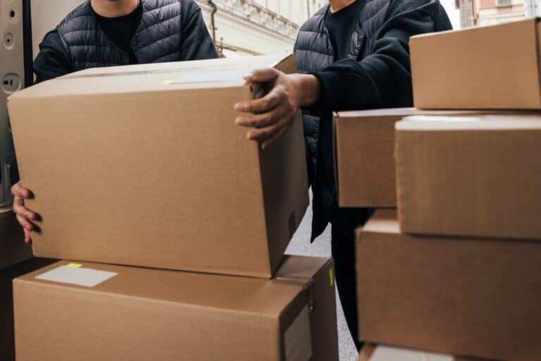 Cropped image of the Man and Van crew at the back of the van placing differently sized boxes in the concept of 'Types of Items Transported by a Man and Van Service in Barnet'.
