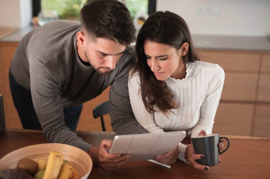 A young couple reviewing the Man and Van's insurance policy