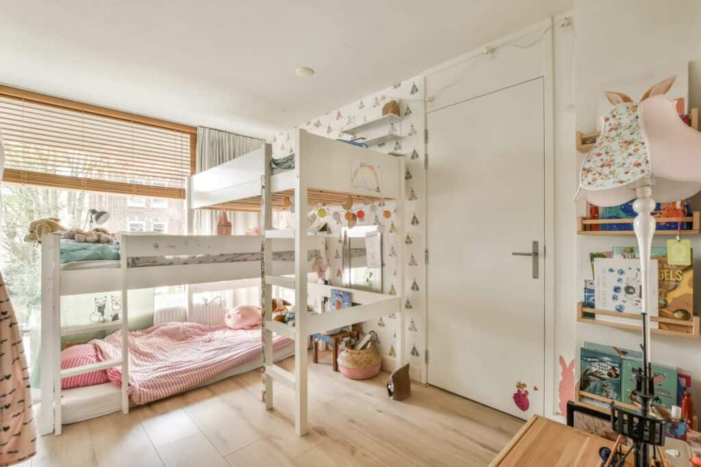 Kids' room with bunk beds, books, and toys