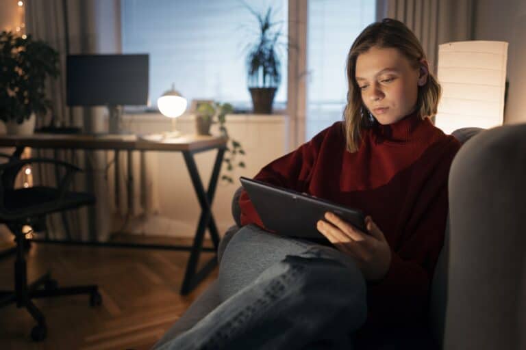 A young woman getting man and van quotes in her tablet in the concept of 'How to Get a Quote for a Man and Van Service'.