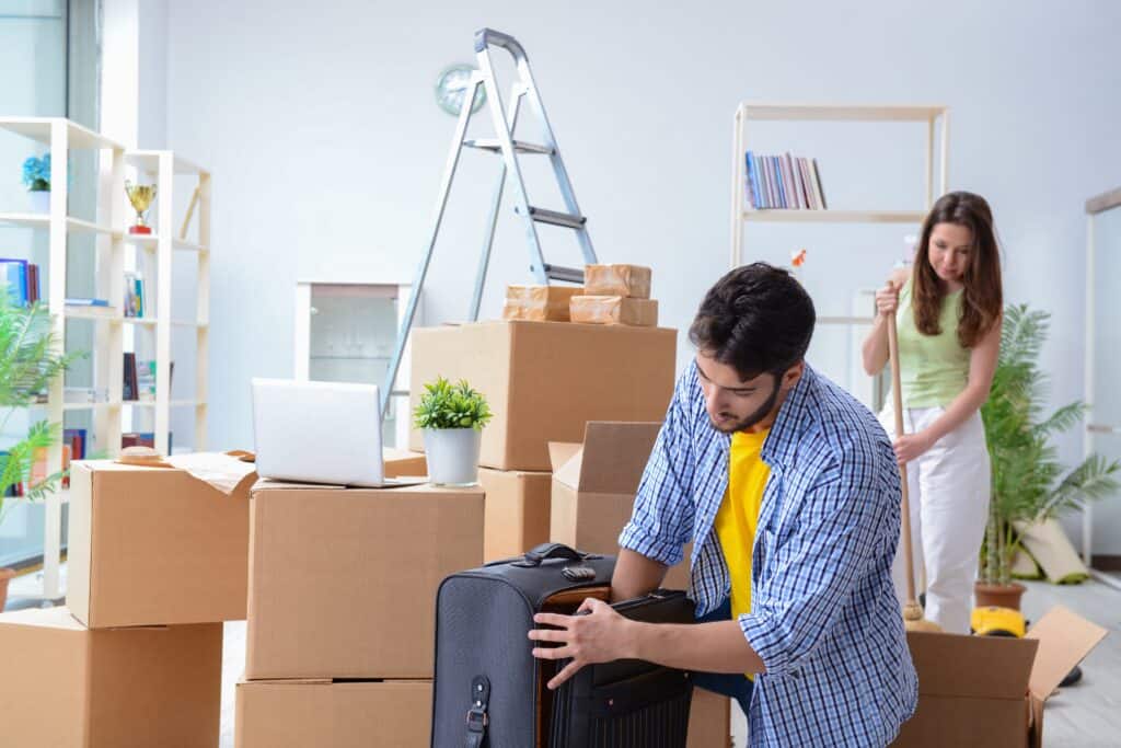 A young couple busy unpacking in their new home